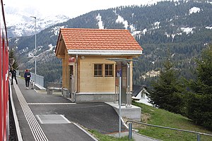 Single-story shelter on a platform with mountains behind