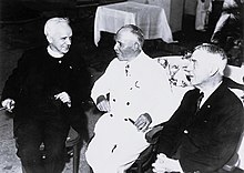 Three men seated together.