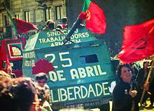 Demonstration with red flags and a green mock tank
