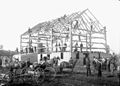 A timber frame barn during the barn raising in Canada
