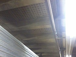 View of the underside of the vault-light floor, supported by tapered concrete beams