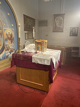 An altar of a Coptic Church, with appropriate coverings, icon of the Pantocrator with Cherubim/Seraphim and Incorporeal beasts, and various other icons.