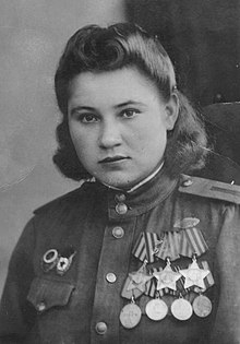 Photograph of Necheporchukova wearing her medals, including her three Orders of Glory