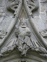The small statue depicting the Holy Father over the entrance to the south porch. He is giving a blessing and holds a terrestrial globe.