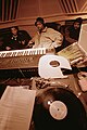Image 16Hip hop producer and rapper RZA in a music studio with two collaborators. Pictured in the foreground is a synthesizer keyboard and a number of vinyl records; both of these items are key tools that producers and DJs use to create hip hop beats. (from Hip hop production)