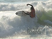 A surfer at Soorts-Hossegor, considered as one of the best surfing spots in the world.[86]