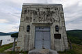 Structure on top of the Waterbury Dam, with a plaque by the door