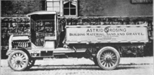 A side-view of a delivery truck in 1915; side is painted to read "Astrid S. Rosing Building Materials, Sand and Gravel"
