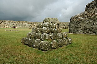 A mound of stone balls arranged in a pyramid shape.