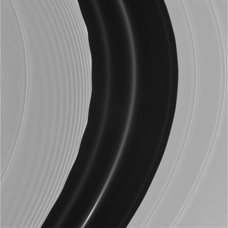 Pan's motion through the A ring's Encke Gap induces edge waves and (non-self-propagating) spiraling wakes[173] ahead of and inward of it. The other more tightly wound bands are spiral density waves.