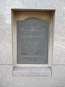 A tablet commemorating the 1848 Stillwater convention. To the top left and top right are the years 1848 and 1948. The text reads: "Birth of Minnesota – On this site, in the frontier river settlement of Stillwater, sixty-one delegates from the vast unorganized wilderness west of the St. Croix assembled on August 26, 1848 to hold the Minnesota Territorial Convention. In this convention the name Minnesota was selected and the spelling agreed upon, a petition was drawn, memorializing Congress to set up a territorial government, and H. H. Sibley was dispatched to Washington as the delegate of the convention bearing the petition." Below this is smaller print, reading: "This tablet erected by the Stillwater Territorial Centennial Committee – August 26, 1948".