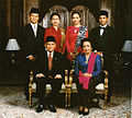 Image 3Formal family portrait of former Indonesian's President B.J. Habibie. Women wear kain batik and kebaya with selendang (sash), while men wear jas and dasi (western suit with tie) with peci cap. (from Culture of Indonesia)