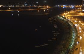 Night view of the boats docked to the east shoreline of Al-Khan Lagoon