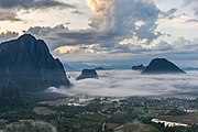 Karst peaks with sea of clouds at sunrise, South view from the top of Mount Nam Xay, Vang Vieng, Laos