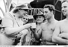 Miss Strella Wilson is offered a mug of tea after her arrival in New Guinea.