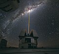 Image 9 Adaptive optics Photo: Yuri Beletsky, ESO A laser shoots towards the centre of the Milky Way from the Very Large Telescope facility in Chile, to provide a laser guide star, a reference point in the sky for the telescope's adaptive optics (AO) system. AO technology improves the performance of optical systems by reducing the effect of atmospheric distortion. AO was first envisioned by Horace W. Babcock in 1953, but did not come into common usage until advances in computer technology during the 1990s made the technique practical. More selected pictures