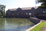 A brick building (the pumping station), water in front