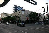 A view of a building at a street corner with red A-Channel signage.