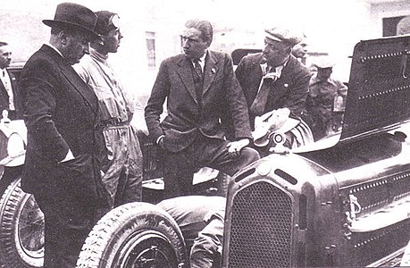 From left: Eduardo Weber, Ramponi, Carlo Felice Trossi and Enzo Ferrari of the Scuderia Ferrari team in June 1933. The car is an Alfa Romeo 8C 2300 "Monza".