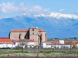 Church of St John the Baptist, Saucedilla with the Sierra de Gredos snow-covered behind
