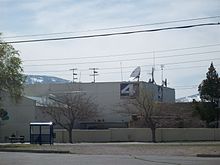 A one-story complex with a KRNV logo sign
