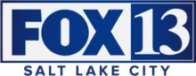 In a white box trimmed in blue, the Fox network logo — the uppercase letters FOX in a sans serif — next to a blue box containing the numeral 13 in a serif. Beneath the box are the words Salt Lake City in a sans serif, tracked slightly wide.