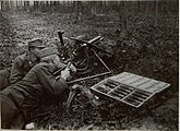M15 with a gun shield and its trail folded backward in a forest.