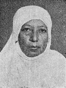 Black-and-white head-and-shoulders portrait of Yunusiyah looking directly into the camera, wearing a hijab with a neutral expression