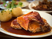 Krustenbraten mit Dunkelbiersoße (baked pork served with a dark beer sauce)