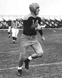 Don Hutson running with a football on the field