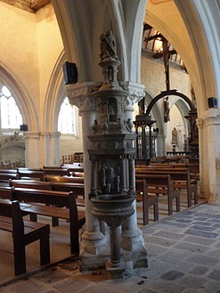 This stoup inside the church has a sculpture at the top depicting Saint Michael fighting the dragon. Over the stoup's basin is a sculpture depicting an angel holding two holy-water sprinklers/aspergillum.("goupillon").[5]