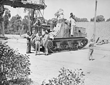Personnel inspect a self propelled artillery vehicle