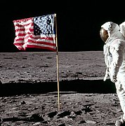 Cropped photo taken a few seconds later. Buzz Aldrin's hand is down, head turned toward the camera; the flag is unchanged.