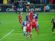 Liverpool and Cardiff players compete for the ball following a Cardiff throw-in.