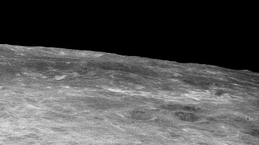 Oblique view with Firsov at center and high-albedo swirls in middle foreground, from Apollo 11