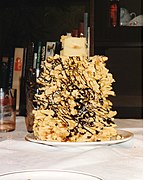Šakotis decorated with chocolate chips and coconut shavings