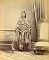 Portrait of a girl from Sindh wearing Sindhi Choli (tunic), Sossi Shalwars under Satin Paro (skirt) with long wide veil, and traditional Sindhi "Tauran wari Jutti"(1870s).
