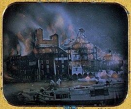 Hand-tinted daguerrotype of the Fire at the Ames and Dolittle Mills, 1853, considered one of the first news photographs.