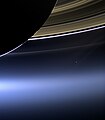 Detail from The Day the Earth Smiled, with Earth as a pale dot between Saturn's rings