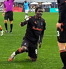 Elimane Cissé kneeling on the pitch and getting up