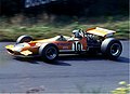Team founder Bruce McLaren is pictured driving the McLaren M7C at the 1969 German Grand Prix.