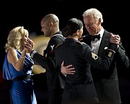 Joe and Jill Biden dancing with members of the U.S. armed forces at the Commander in Chief's Ball. Silk blue gown by Vera Wang.[95]