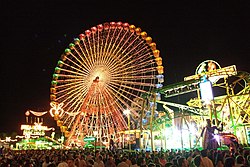 Ferris Wheel and other fair attractions, shown at night