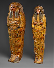 Two yellow mummy-shaped coffins standing upright