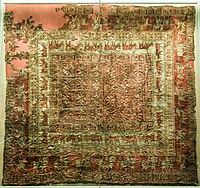 Decorated carpet from Pazyryk-5, of Near-Eastern origin. This is the earliest surviving knotted-pile carpet.[43]