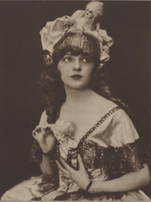 A young white woman wearing a showgirl costume, from 1921.