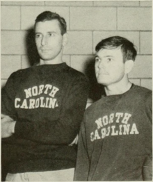 A black and white photograph of two white men wearing sweatshirts that say "NORTH CAROLINA"