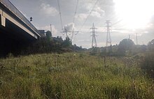 Electricity transmission towers to be relocated for works of an elevated rail over the M80 Ring Roaf (left of image).