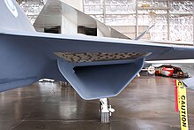 A close up shot of the YF-23's S-duct engine air intake located below the right wing