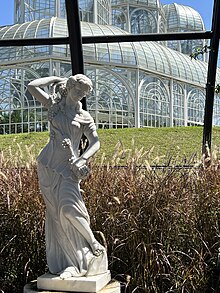 Greek statue of a woman holding grapes overlooking the main greenhouse from the Frans Krajcberg Gallery